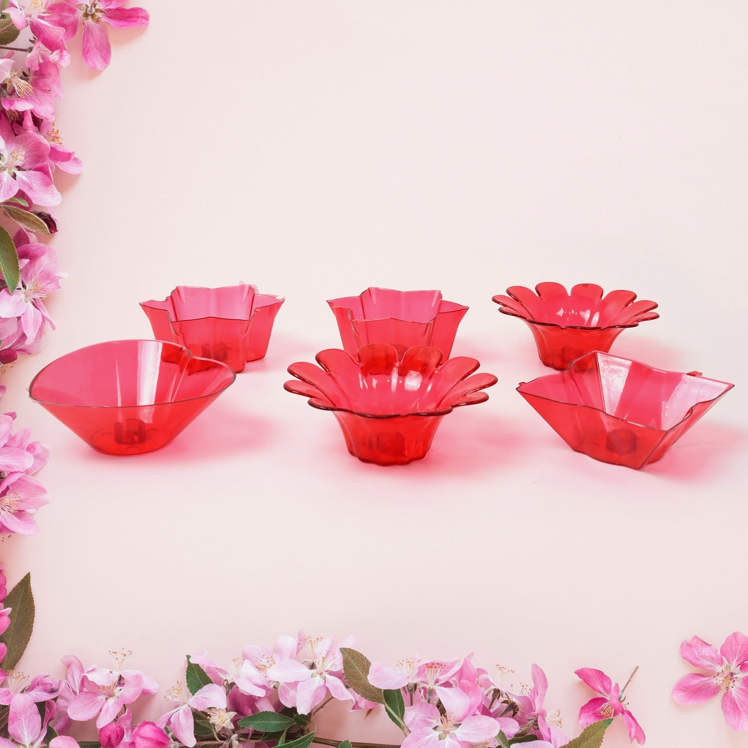 Variety of colorful plastic diyas from the 12-piece set, perfect for any celebration.