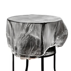 Thick transparent disposable plastic furniture cover protecting a sofa.