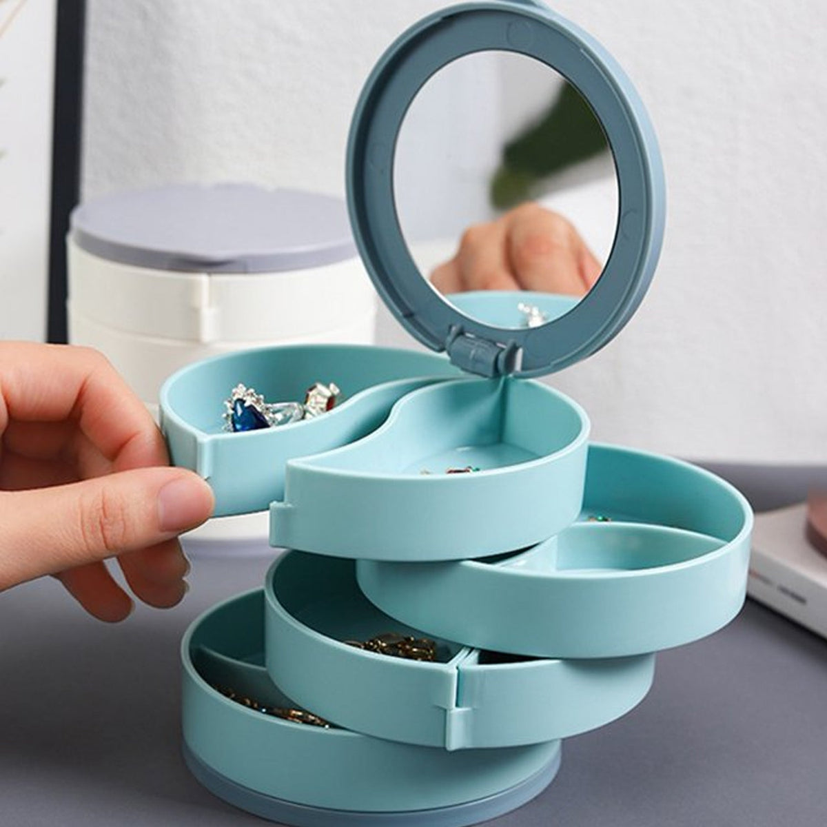 4-layer 360-degree rotating jewellery box with mirror for organized storage.