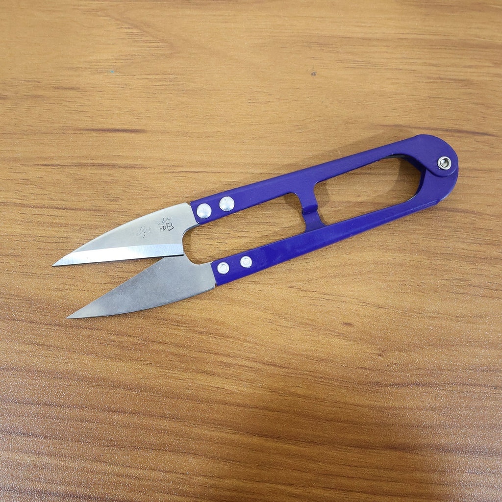 Angled view of premium ergonomic sewing scissors with stainless steel blades