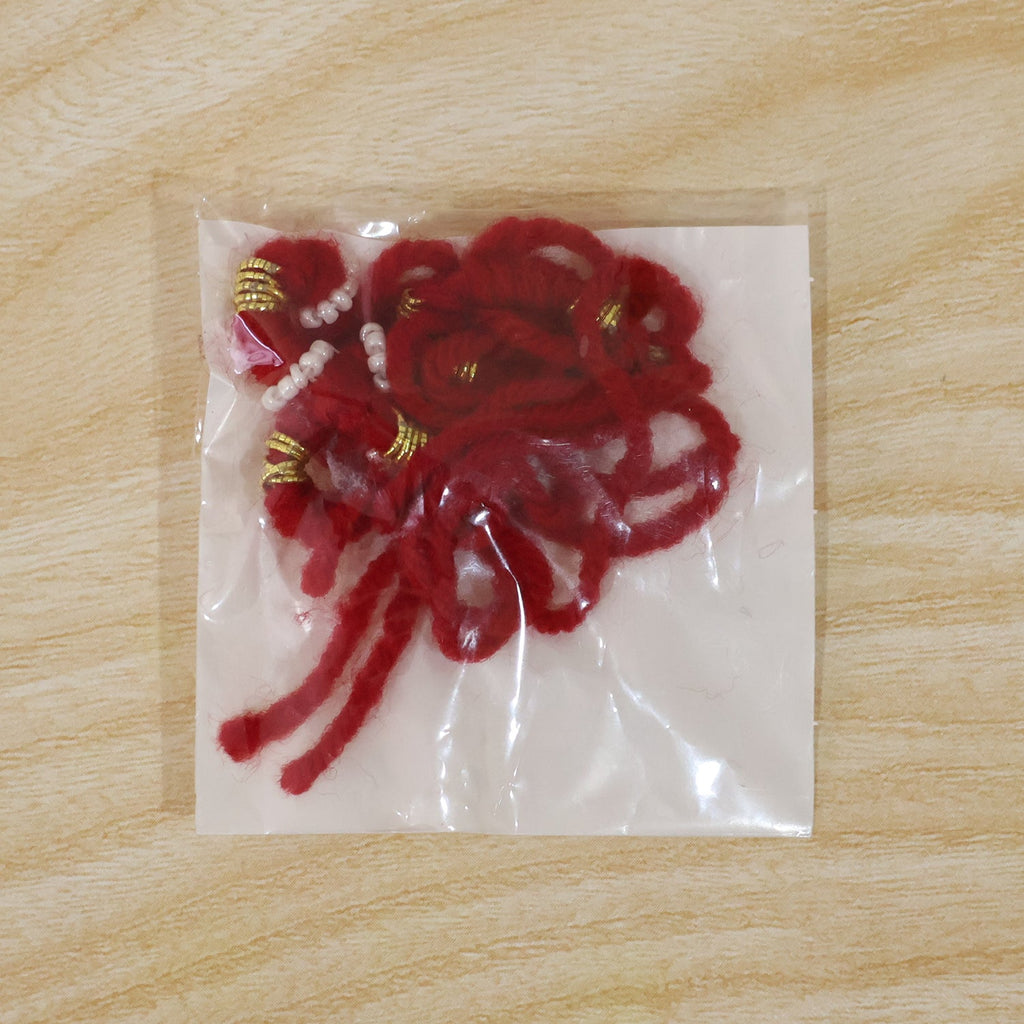 Detailed view of red rakhi beads and thread
