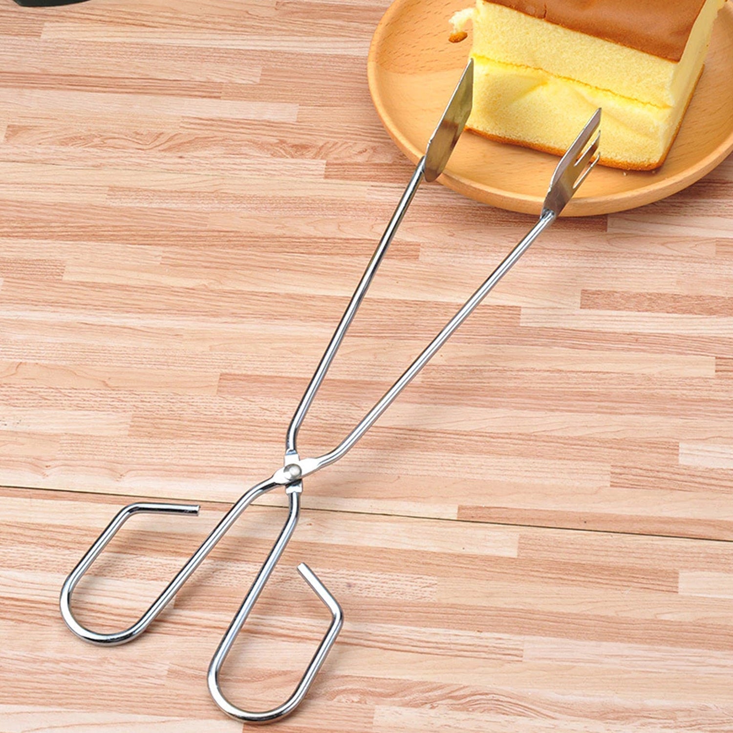 Long handle cooking tong for safe barbecue grilling.