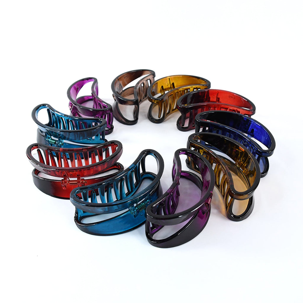 Close-up of plastic hair clamp grip showing classic claw design for hair fixation.