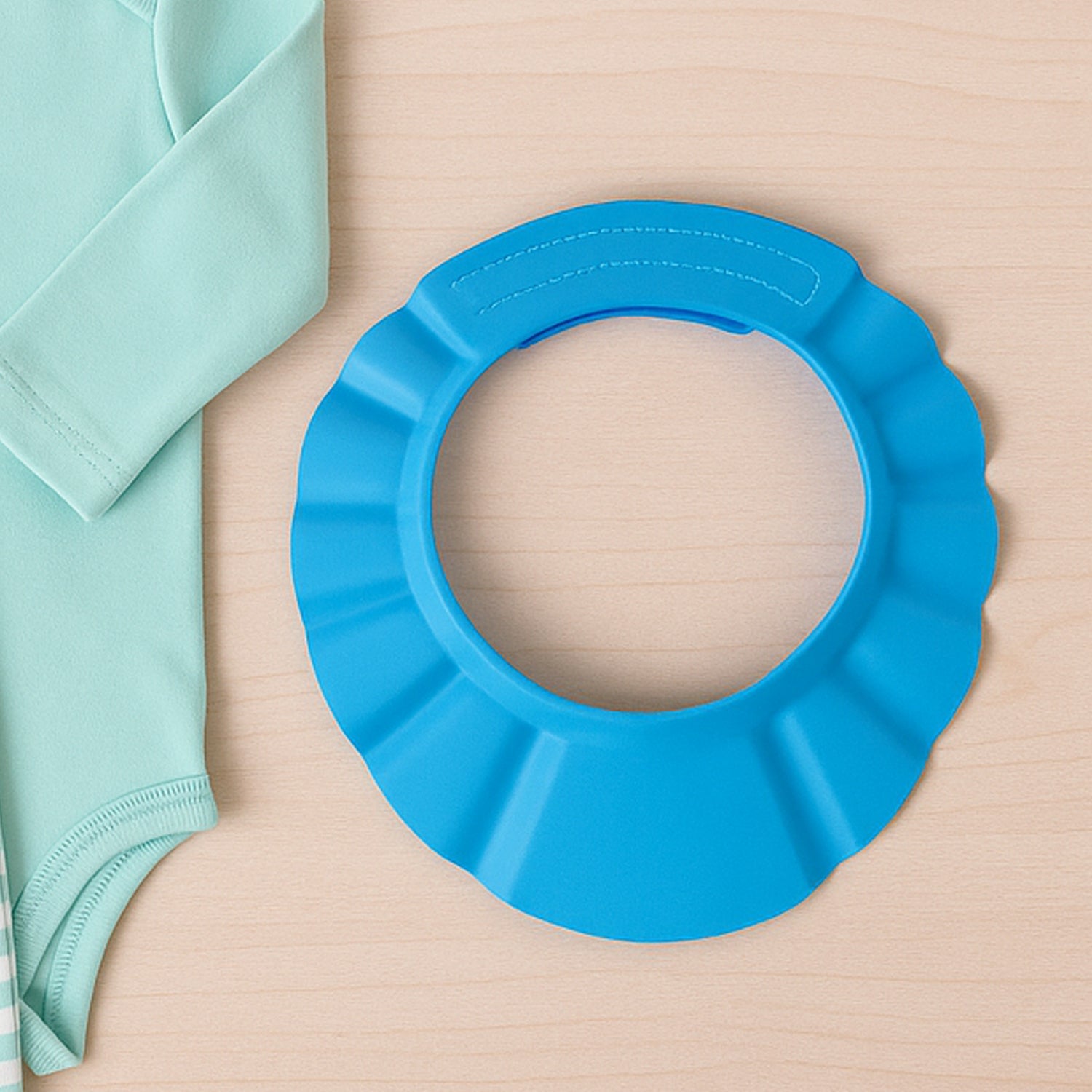 Soft and flexible baby shower hat protecting infant’s eyes and ears