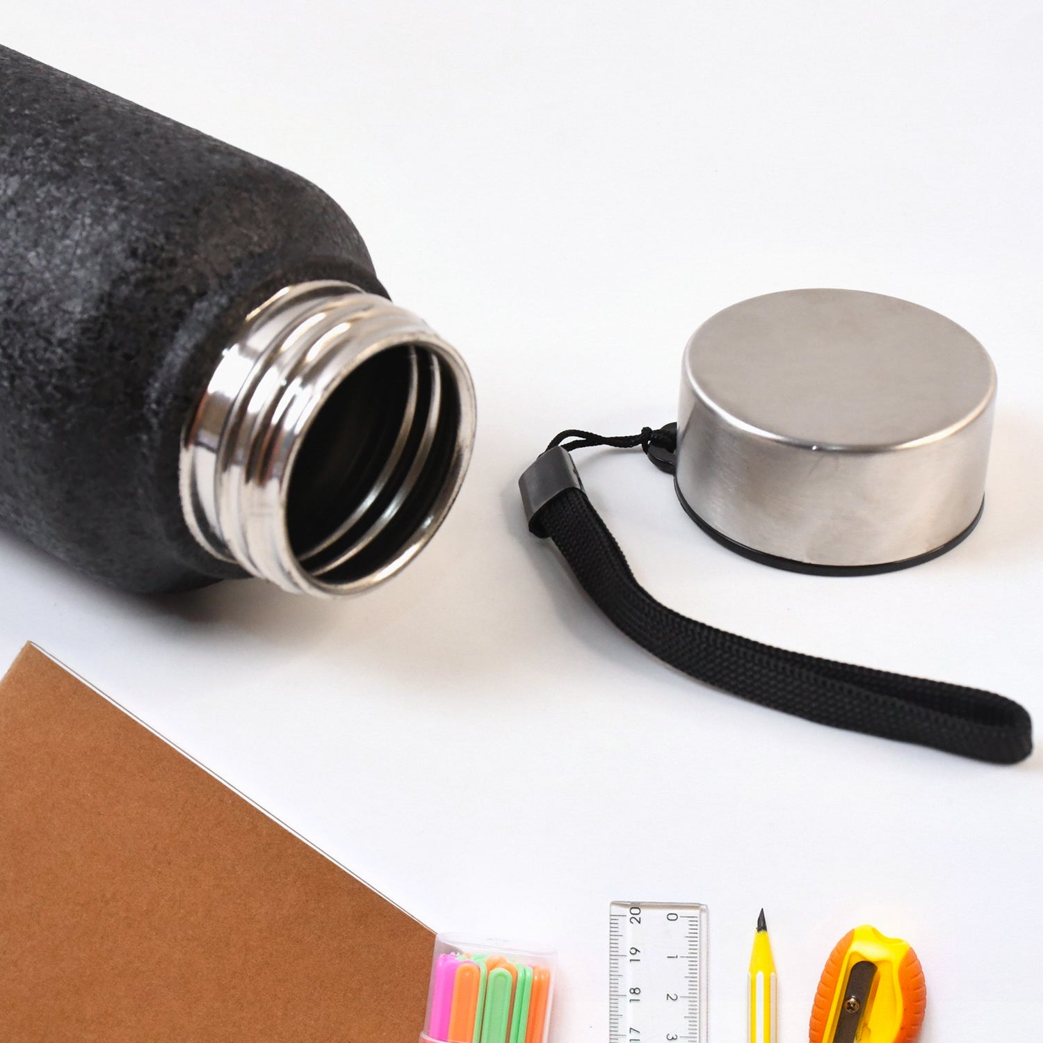 Person holding 1 litre black stainless steel vacuum insulated water bottle