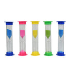 A green sand timer on a desk, assisting with focus and productivity during work or study.