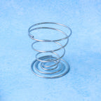 Modern stainless steel spiral egg cup holder enhancing dining presentation