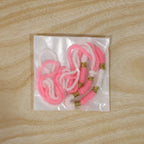 Detail shot of Pink & White Thread Rakhi with golden beads