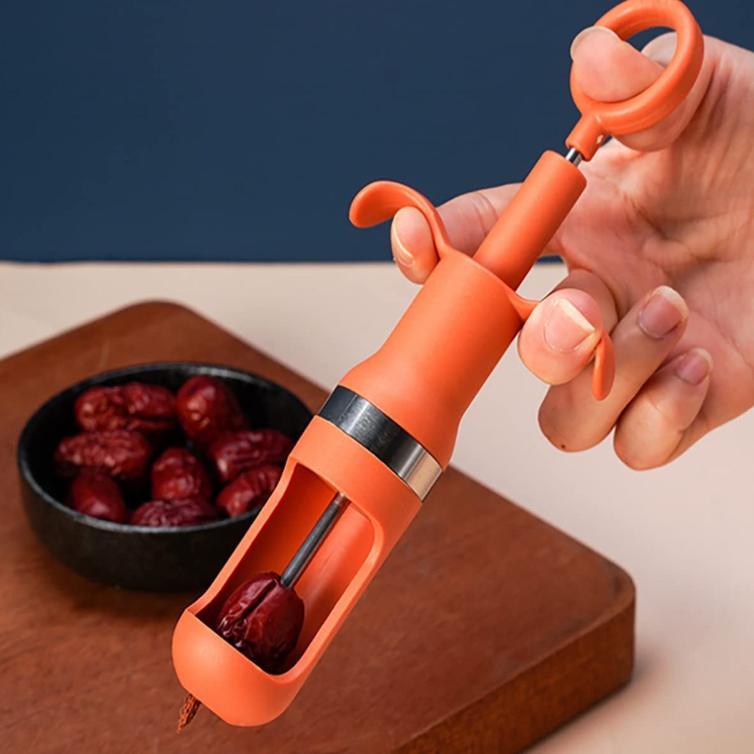 Ergonomic cherry pitter tool for effortless one-hand operation.