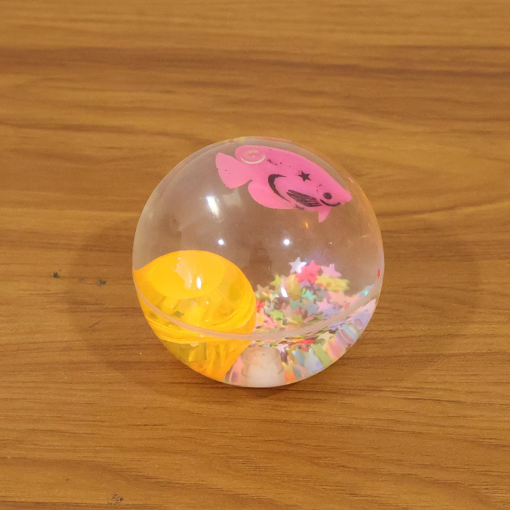 Light-up transparent sensory bouncy ball being used for fun
