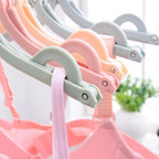Durable folding travel hangers shown organising and drying clothes with ease.