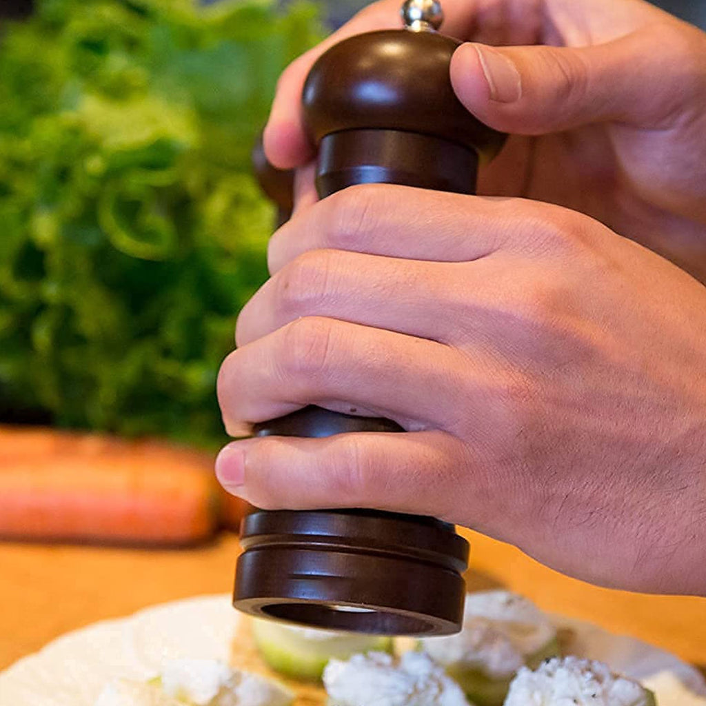 Top view of the adjustable ceramic grinder on the wooden pepper mill, showing the control nut.