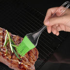 Complete view of the flexible silicone spatula and brush set on a counter.