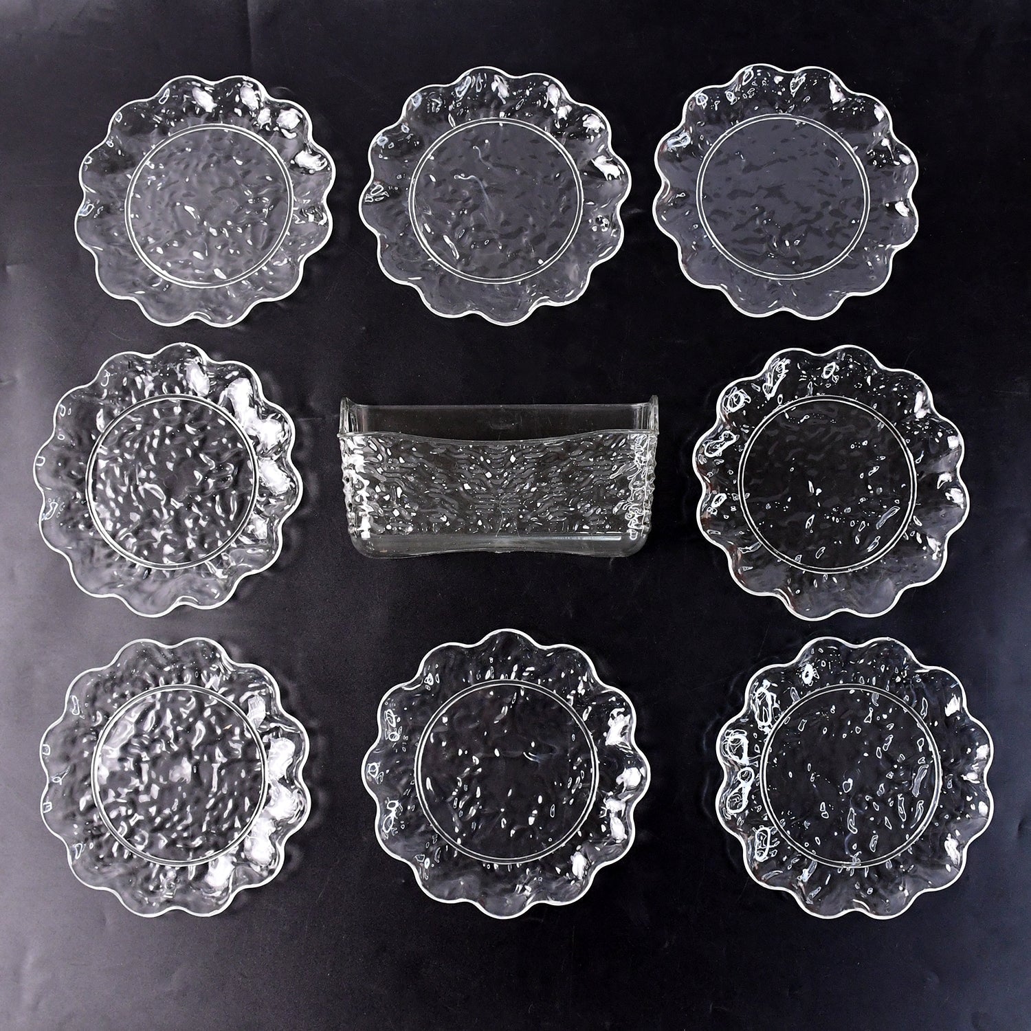 9-piece plastic bowl set with serving tray displaying transparent bowls and plates