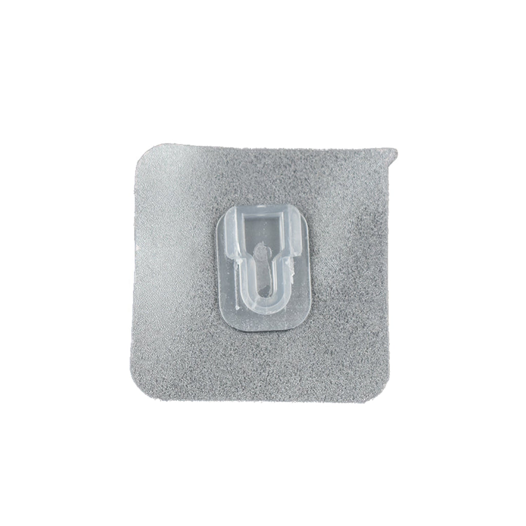 GlimmerHome transparent adhesive hook discreetly blending into a white wall.