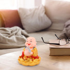 The peaceful expression of the Solar Buddha Car Ornament, ideal for dashboard decoration.