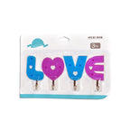 Multiple love shape self adhesive hooks organized on a kitchen wall.