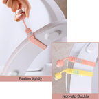 Reusable silicone toilet seat lifter securely attached to a toilet seat.
