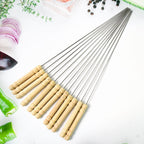 A complete set of 12 stainless steel BBQ skewers with comfortable wooden handles.