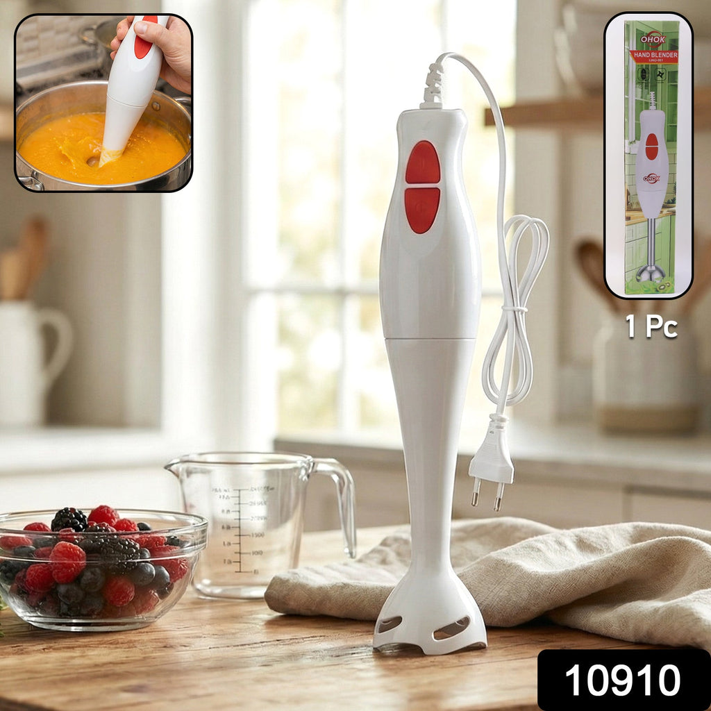 Electric hand blender stick mixing smoothie in a glass