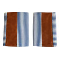Pair of leather and cotton pillow covers on a modern sofa