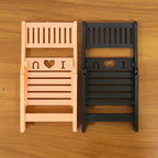 Foldable mini chair mobile phone stand displayed on white background