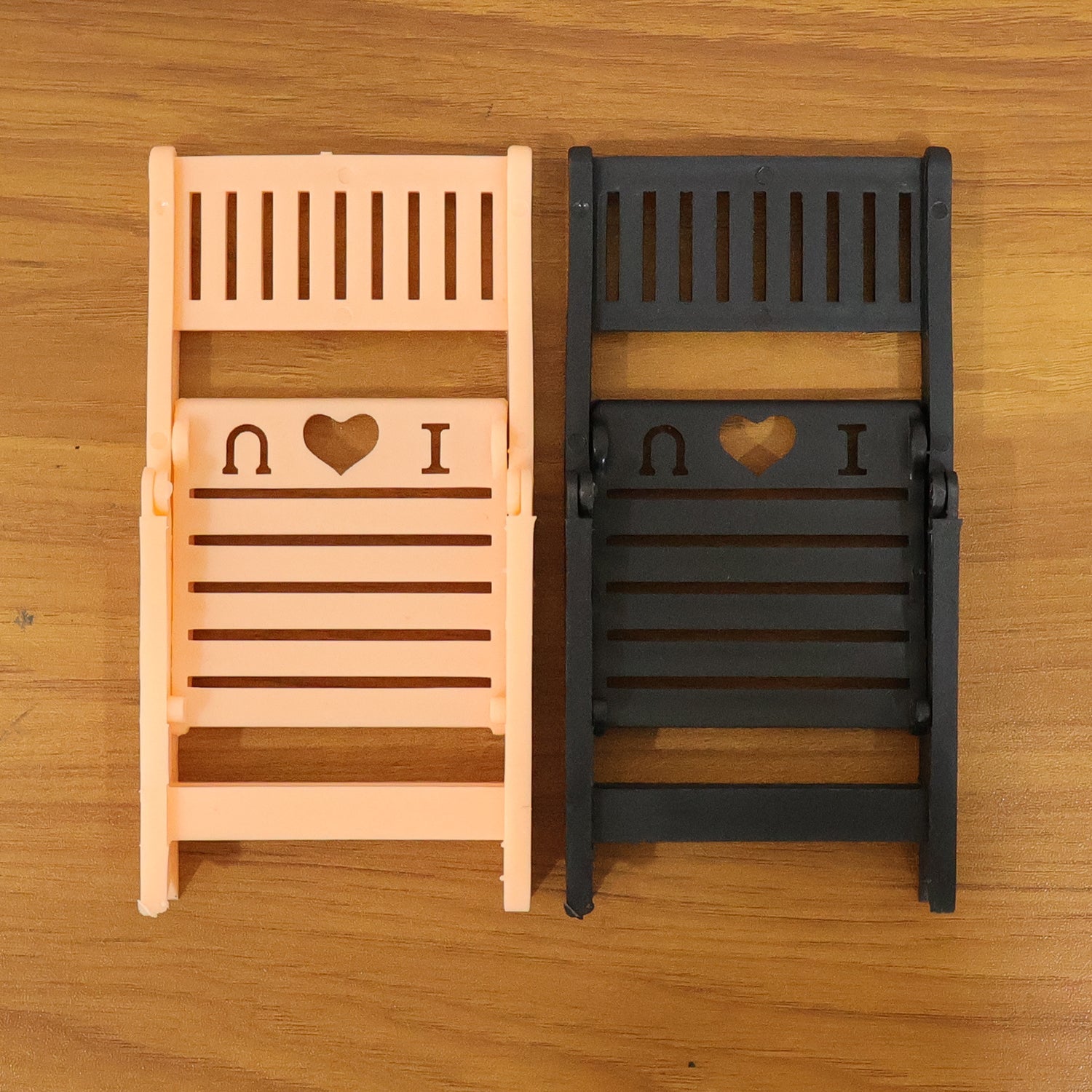 Foldable mini chair mobile phone stand displayed on white background