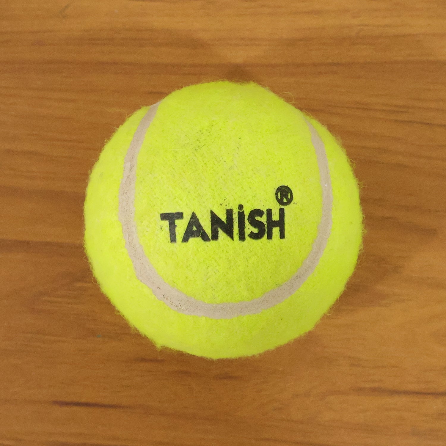 Tennis ball with bright color for easy visibility during outdoor games