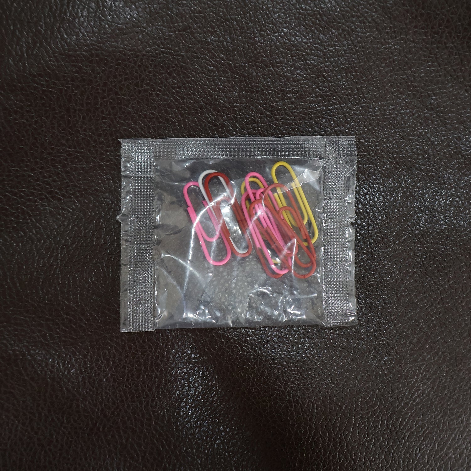 Colourful vinyl-coated paper clips securely holding important files and documents together.