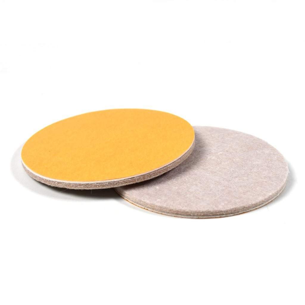 Detailed close-up showing the peel-off adhesive backing of a round cork coaster for easy application.