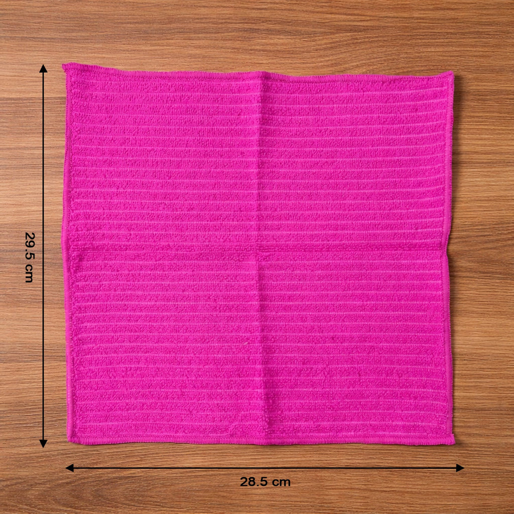 Microfiber cleaning cloth in use wiping a smooth surface