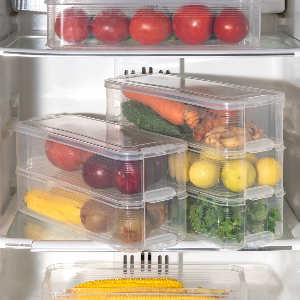 Hand placing a stackable fridge storage container into a clean and organized refrigerator.