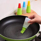 Silicone oil dispenser bottle with integrated basting brush for easy cooking.