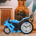 Retro Motorcycle Alarm Clock with a shiny silver finish, viewed from a slight angle on a white surface.