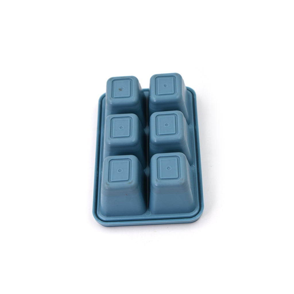 Hands gently bending the flexible blue silicone ice tray to release ice cubes.