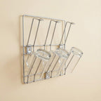 Wall-mounted stainless steel cup rack holding multiple drinkware