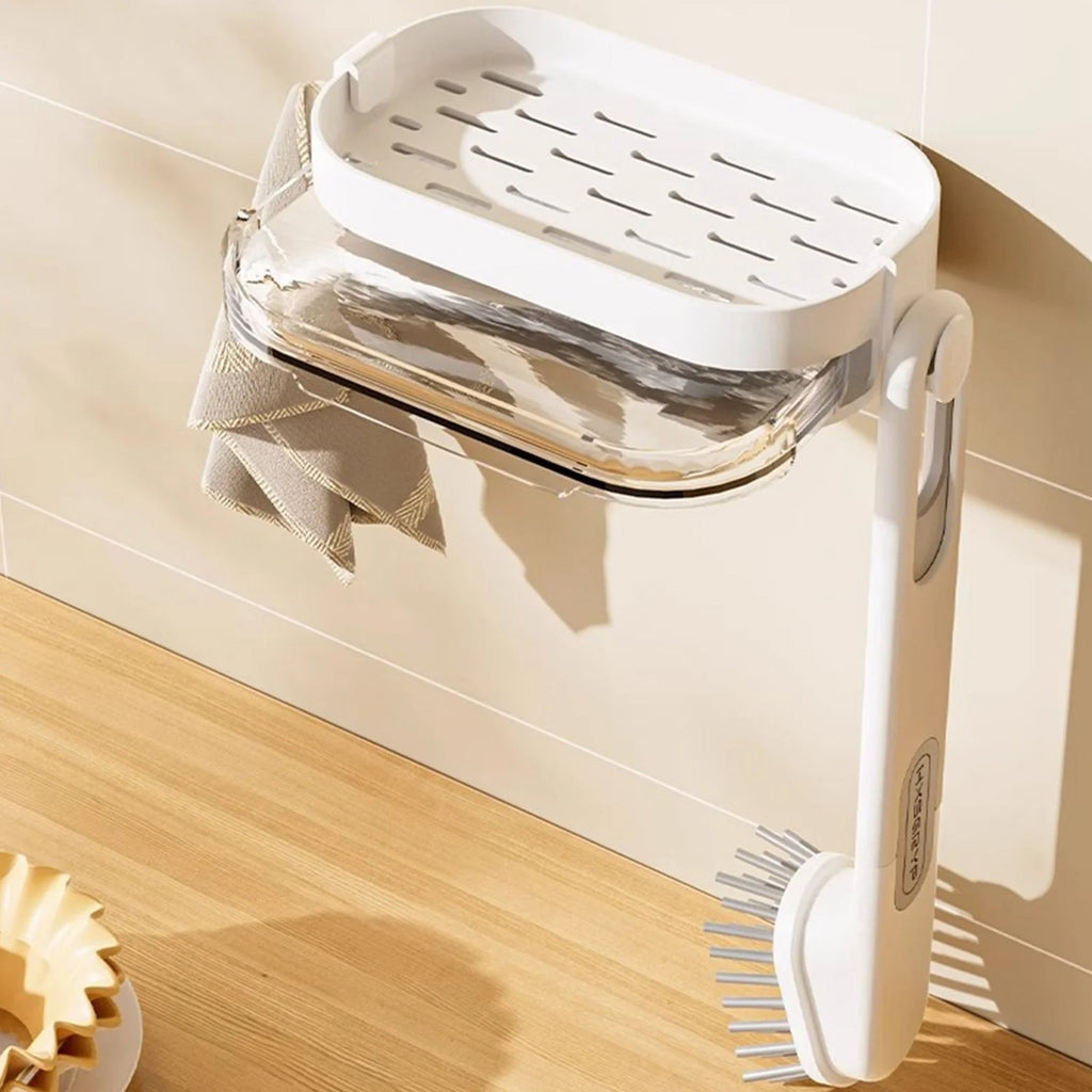 Cleaning brush stored in wall mounted holder with tray organizer