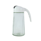 Glass oil bottle dispenser among kitchen condiments and utensils