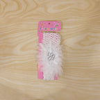 Elegant baby hair accessory featuring floral bow and elastic fabric