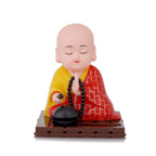 Solar-powered Buddha idol with a moving hand gesture, perfect for positive energy.