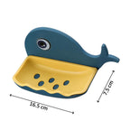 Lifestyle image of the fish shape soap dish used in a kitchen sink area for convenience.