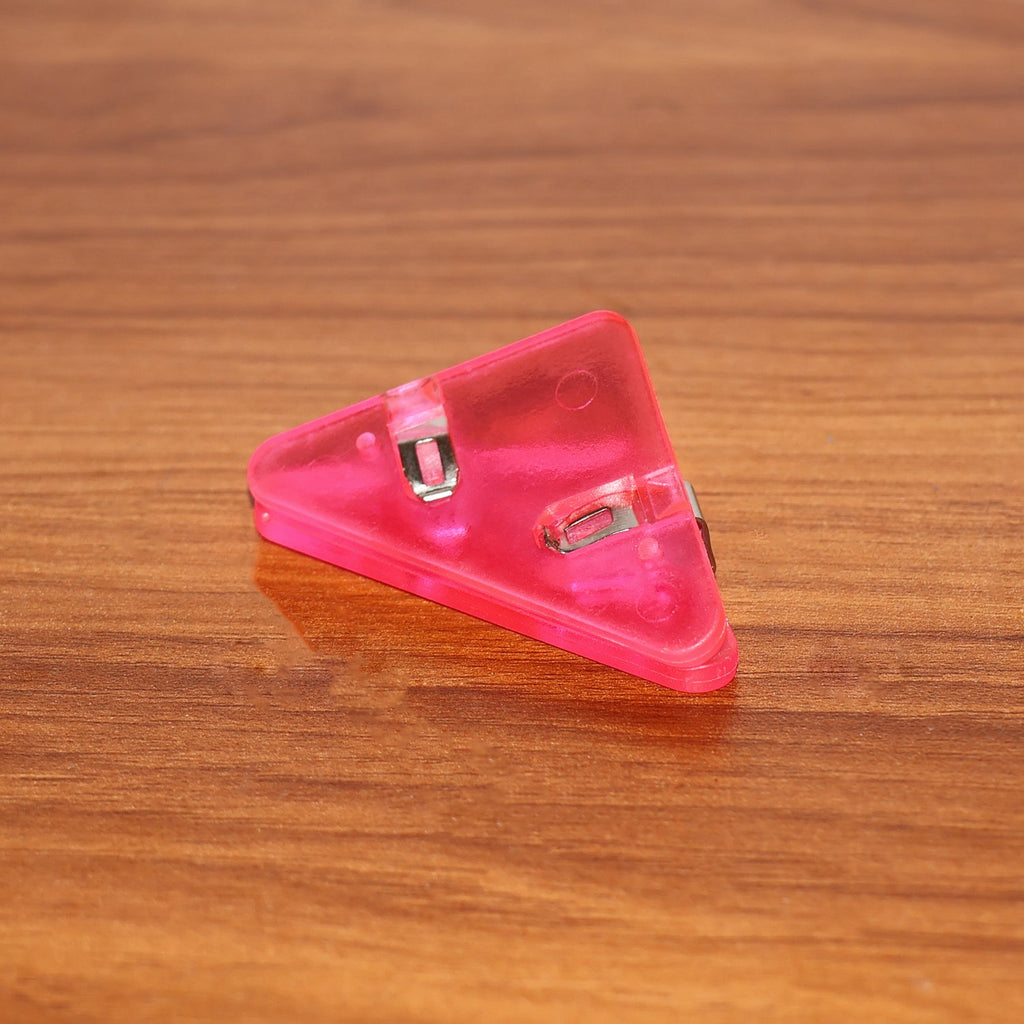 Triangle paper clips securing book pages efficiently