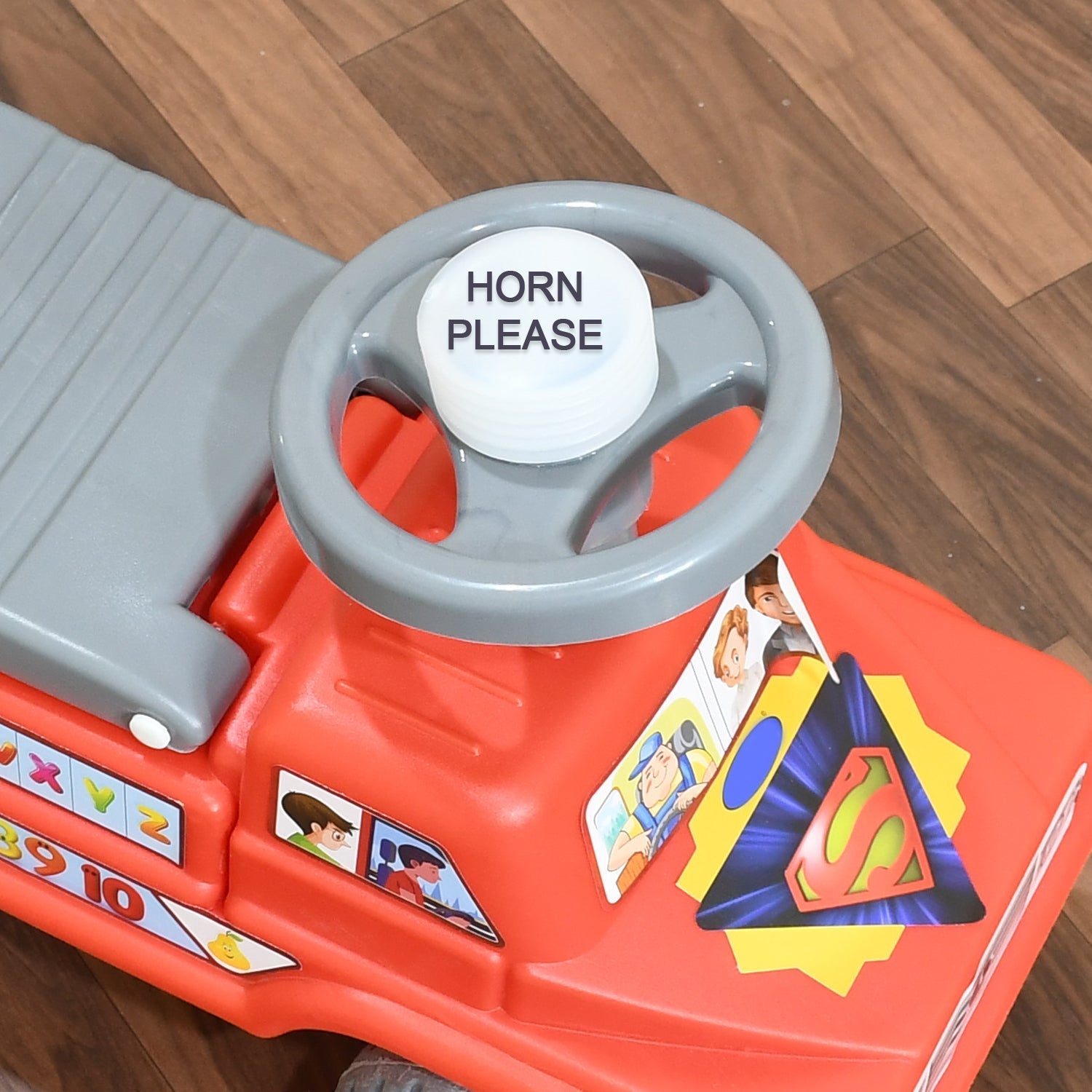 Happy baby playing with the versatile ride-on car toy.