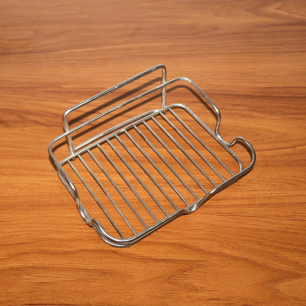 Stainless steel soap holder placed beside kitchen sink area for soap storage