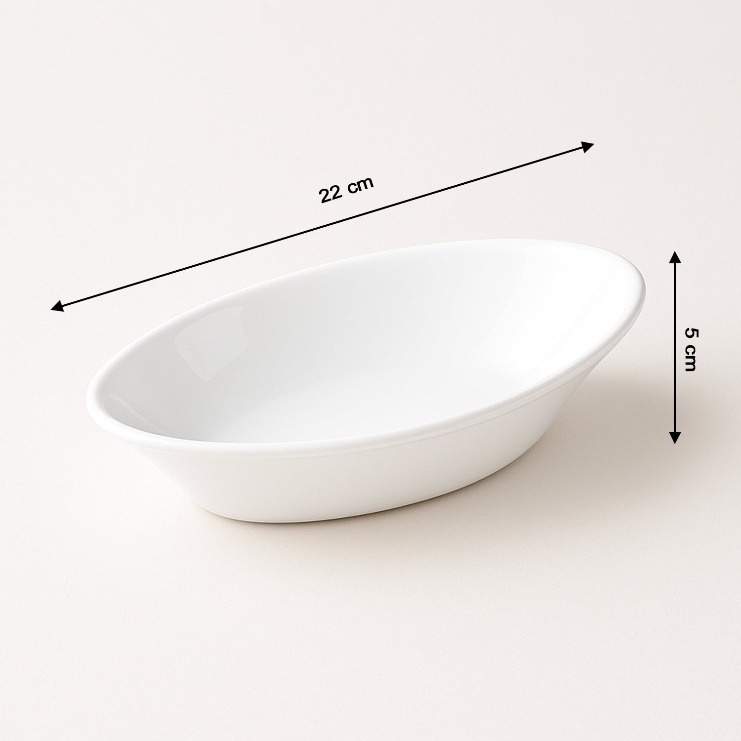 White Marin oval serving bowl placed next to other kitchenware items