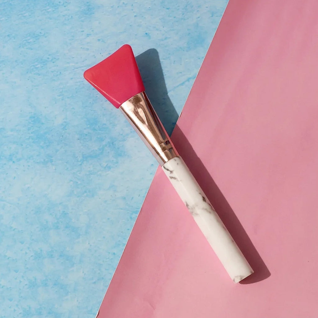Using silicone face mask brush to apply facial mask smoothly
