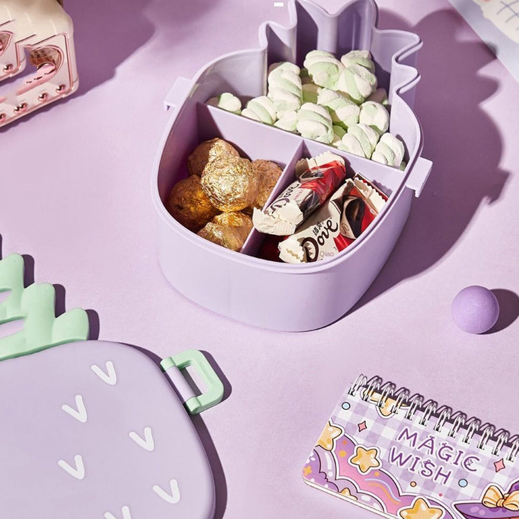 A child's pineapple bento box filled with colorful sushi and fresh fruits.