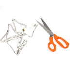 Sharp tailor scissors and a flexible measuring tape laid on a surface, ready for use.