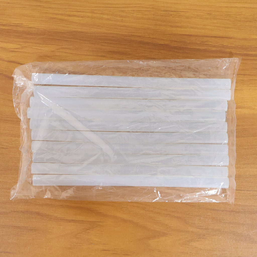 Hot glue sticking wood, fabric, and paper for craft projects