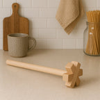 Wooden blender actively smashing vegetables in a bowl for cooking.
